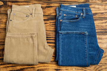 corduroy jeans and regular jeans on a wooden background.