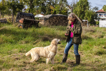 Friendly female Dog Trainer with Golden Retriever
