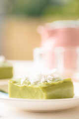 Pandanus pudding with coconut topping on white background, Traditional sweets that are cultural heritage of Asia.