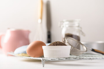 Organic perilla seeds in a ceramic bowl on white background. Natural products, healthy baking ingredients