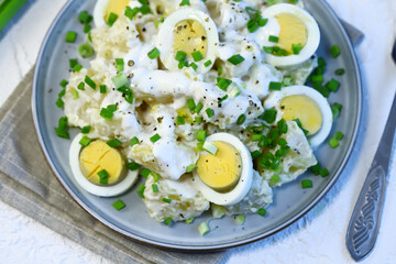 Selective focus. Healthy potato salad with yogurt sauce, egg and green onion. Vegetarian salad.