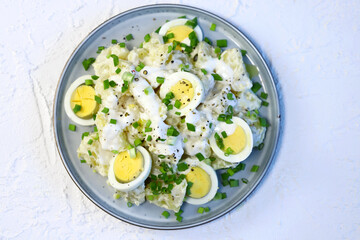 Selective focus. Healthy potato salad with yogurt sauce, egg and green onion. Vegetarian salad.