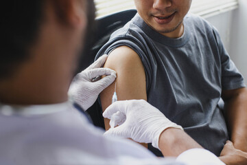 Close up of The arm of the patient who is being injected with vaccine or antibodies on his arm