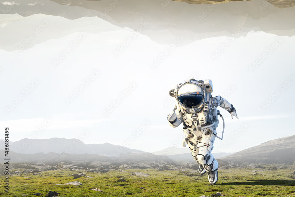 Canvas Prints astronaut walking on an unexplored planet