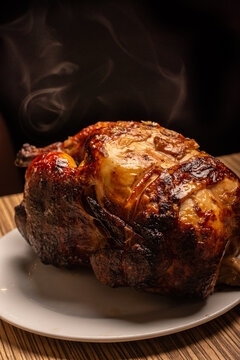 Peruvian grilled chicken. Rotisserie chicken on a black background.