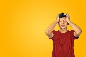 Worried young man with hands on his head. Headache