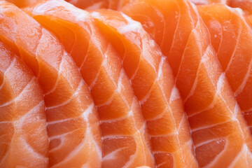 close up salmon fillet slices texture.Row salmon fish sliced on plate at Japanese restaurant.
