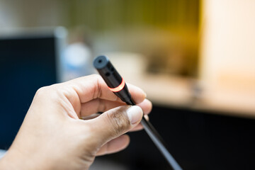 Close up businessman hand holding microphone for presentation and brainstorm strategy workshop business in the meeting room.Student present research.