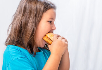 Hungry child bite burger