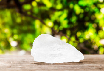 Crystal clear alum cubes or Potassium alum on brown wood plank. Chemical compound substance. Concept for beauty , spa and underarm treatment industrial. 