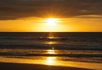 Sunset on ecuadorian beach at golden hour