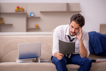 Young male employee working from home during pandemic