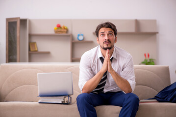 Young male employee working from home during pandemic