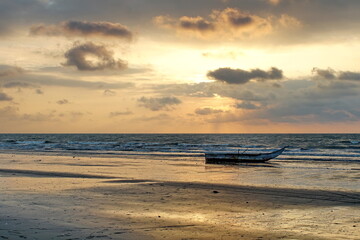 Fishing boat on the beach at sunset in Las Penas, Ecuador