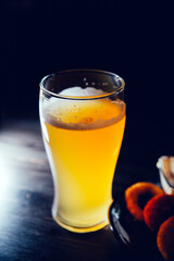 Glass glass of beer and breaded onion rings on a bar counter