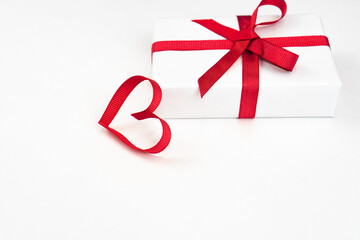White boxes with red ribbons and decorative heart isolated on white background