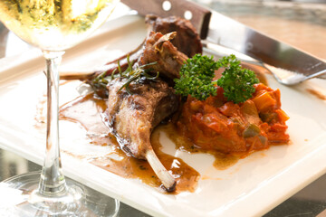 Grilled lamb and glass of wine at restaurant. Hot Meat Dishes