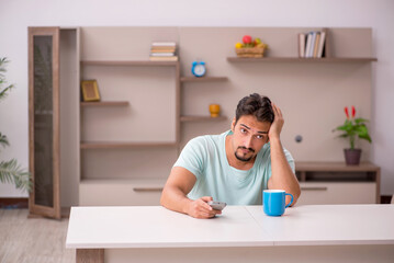 Young man watching tv at home