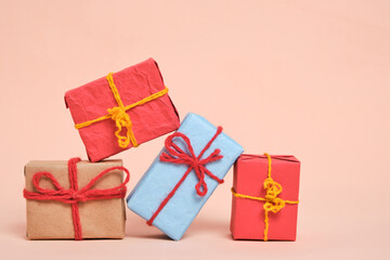 Gifts packed in multicolored paper on pastel beige background.Concept Christmas holidays and eighth March in spring.