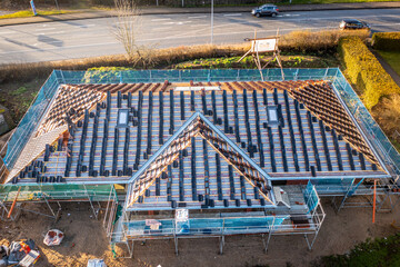 on the newly built house is in the process of covering the roof with tiles