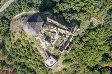 Aerial top down view of Somosko medieval castle between Slovakia and Hungary on a hilltop with triangle shape and three round towers