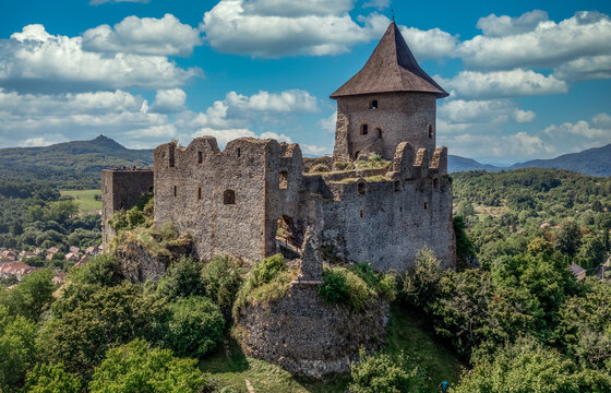 Aerial view of Somosko medieval castle between Slovakia and Hungary on a hilltop with triangle shape and three round towers, one cowered with a roof