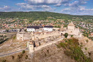 Fototapeta na wymiar Aerial view of medieval Sumeg castle close to lake Balaton in Hungary forming a triangle shape on a hilltop with newly restored Gothic palace