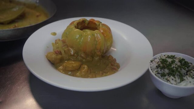 Assembling the gourmet dish Camar&atilde;o na Moranga