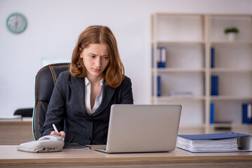 Young female employee working in the office