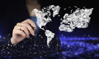 Global world telecommunication network. Hand holding digital graphic pen and drawing digital hologram world, earth, map, globe sign on city dark blurred background. Rule the world, world domination