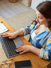 Close-up brunette woman using laptop, remote work at home, online consultation, training