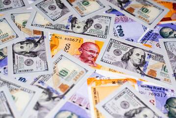 American one hundred dollar bill and Indian paper currency banknote on table as a backgrounds.