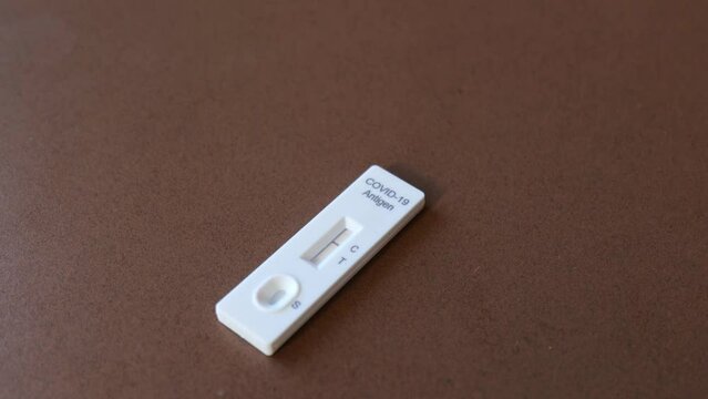 Covid 19 antigen rapid test kit with positive result for infection. Coronavirus rapid self-test home kit close-up image	
