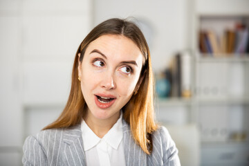 Fototapeta premium Portrait of contemplative European young woman manager in suit.