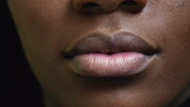 A black girl close-up mouth an african woman face macro