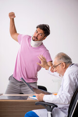 Young neck injured male patient visiting old male doctor