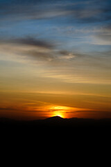 Fototapeta na wymiar Shilhouette mountain in sunset sky with clouds.