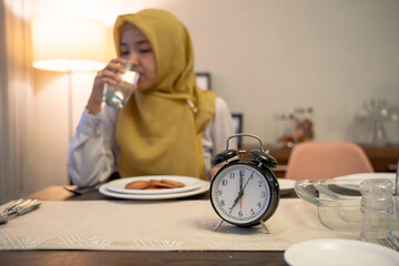 muslim woman drinking a glass of water on breakfasting
