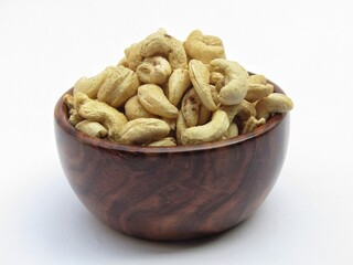 Cashew nut in a wooden bowl on white background 