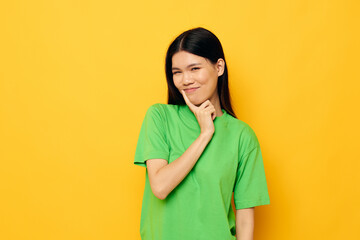 woman with Asian appearance posing in green t-shirt emotions copy-space Lifestyle unaltered