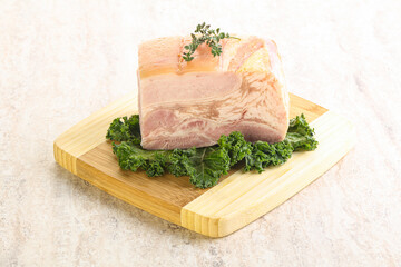 Cut of pork bacon over board