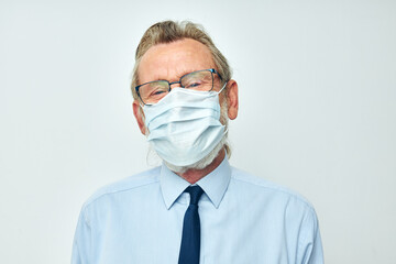 old man in shirt with tie medical mask safety light background