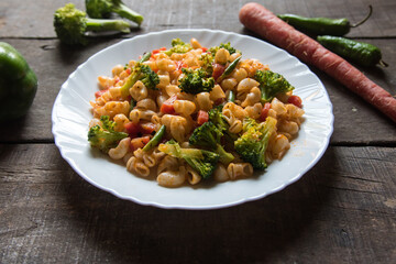 Popular Italian food macaroni pasta cooked in sauce served.  Close up.
