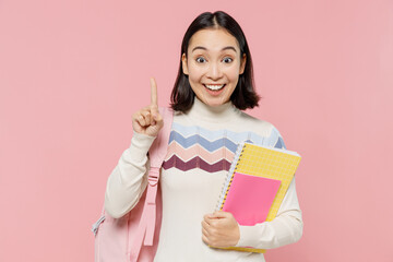 Teen student girl of Asian ethnicity in sweater backpack hold books holding index finger up with...