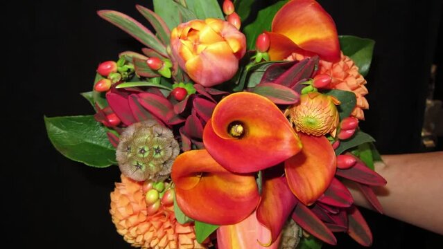 Wedding Bridal Bouquet with bright orange flowers. Slow zoom out.