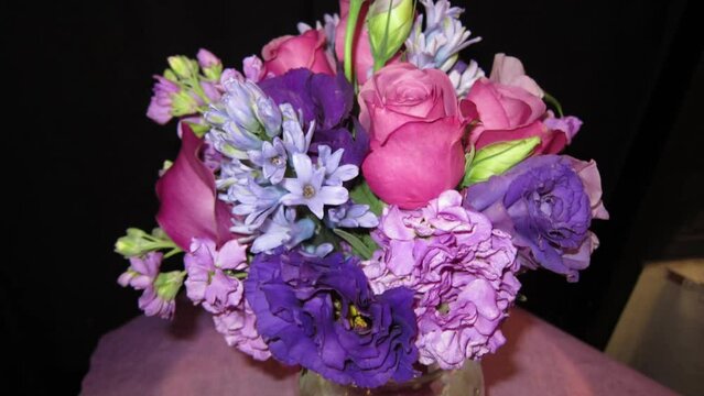 Purple and lavender bouquet of flowers. Slow center zoom out.