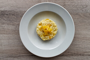 Italian Pumpkin Risotto isolated on wooden background