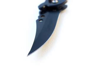 Isolated designer black knife. Isolated knife with textured white background. knife on paper