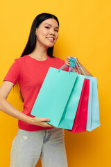 Charming young Asian woman with colorful bags posing shopping fun Lifestyle unaltered