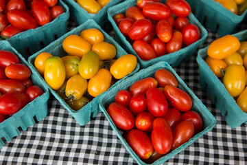 Close-up of cherry tomatoes in containers on market stand